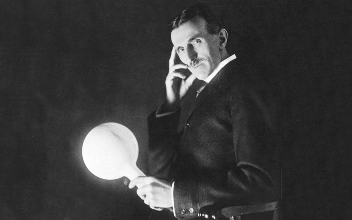 Tesla holding a lightbulb