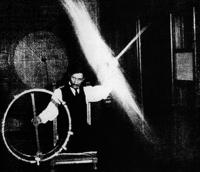 Tesla holding a wheel and electicity staff