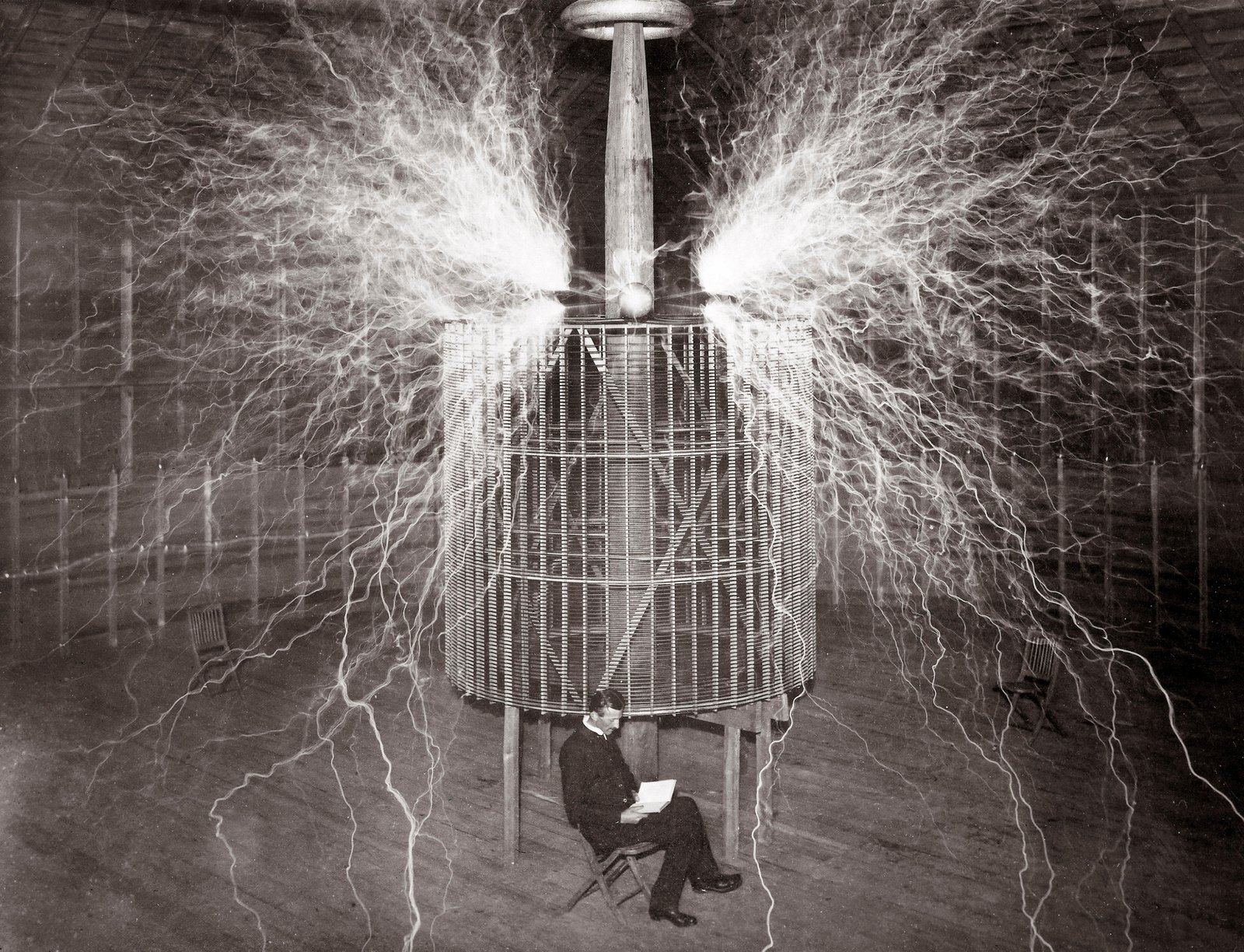 Tesla reading favorite book sitting infront of electricity